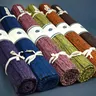 Row of rolled yoga mats in assorted colors (illustrative photo)