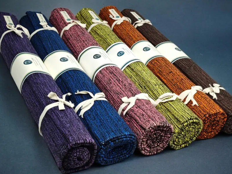 Row of rolled yoga mats in assorted colors (illustrative photo)